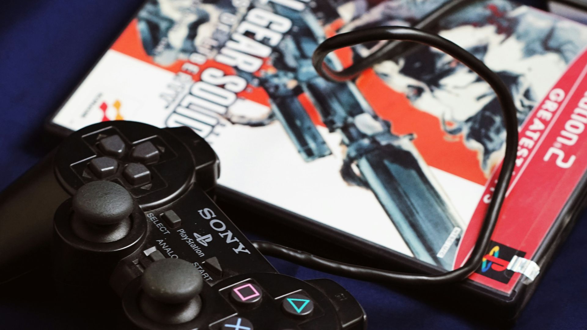 a couple of video game controllers sitting next to a dvd