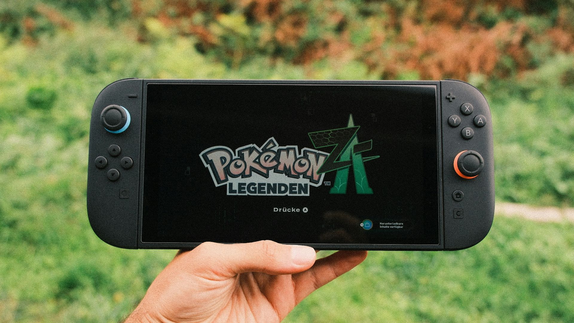 Hand holding a nintendo switch playing pokémon legends