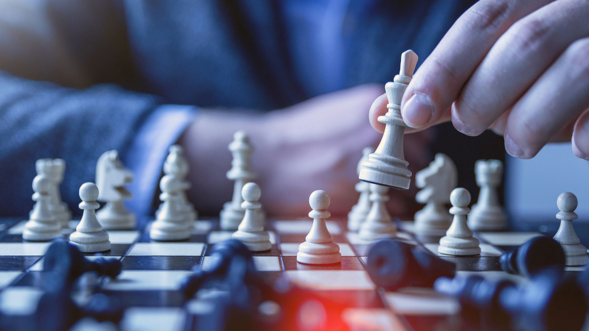 depth of field photography of man playing chess