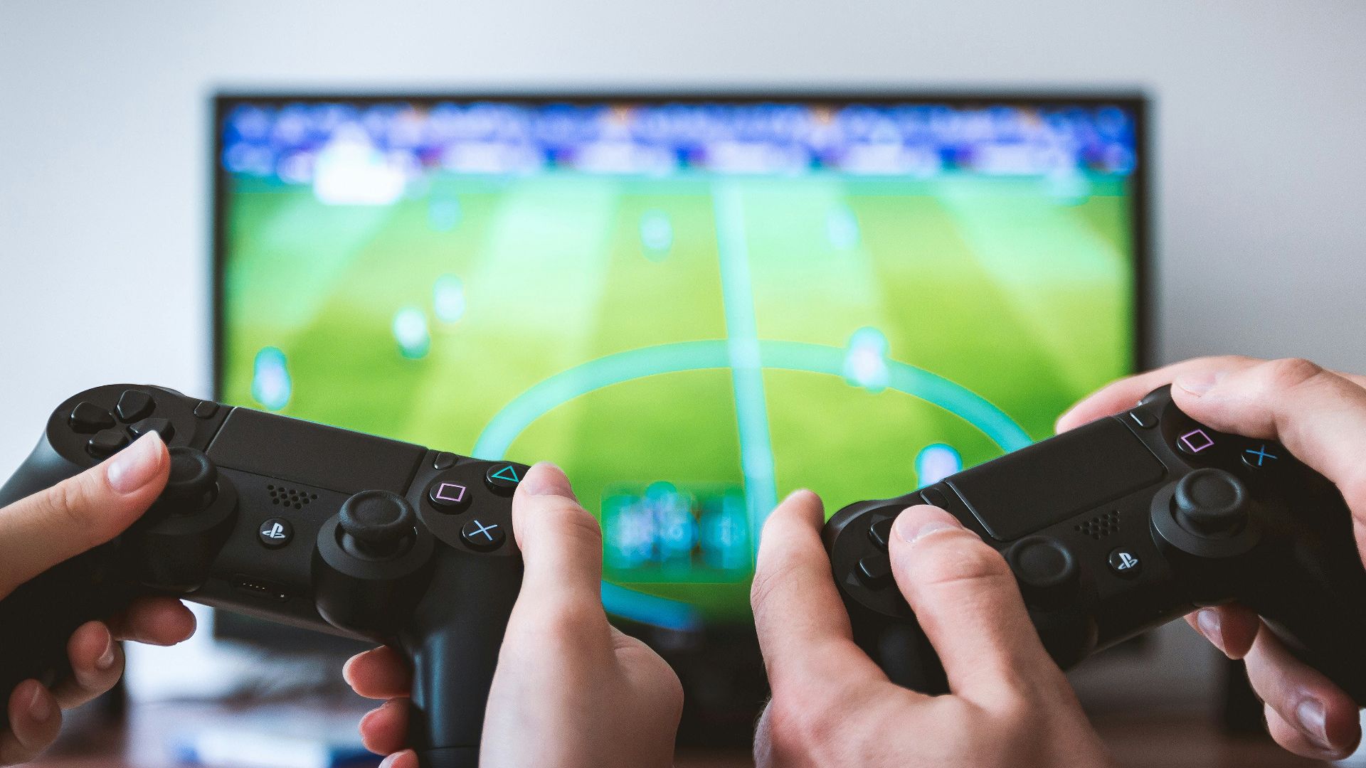 two people playing Sony PS4 game console