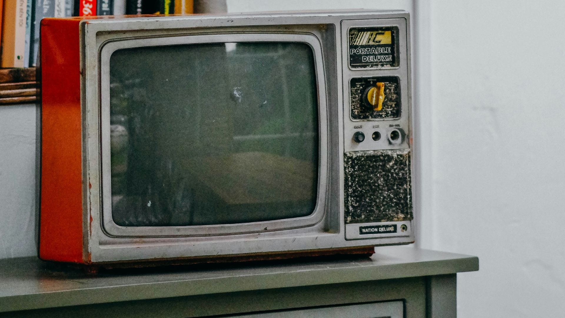 an old television sitting on top of a dresser