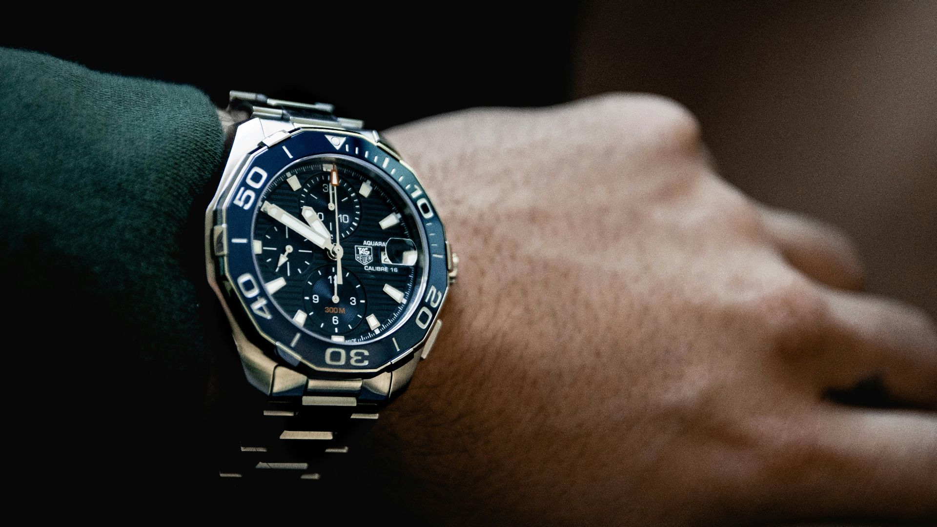 round black chronograph watch at 5:50