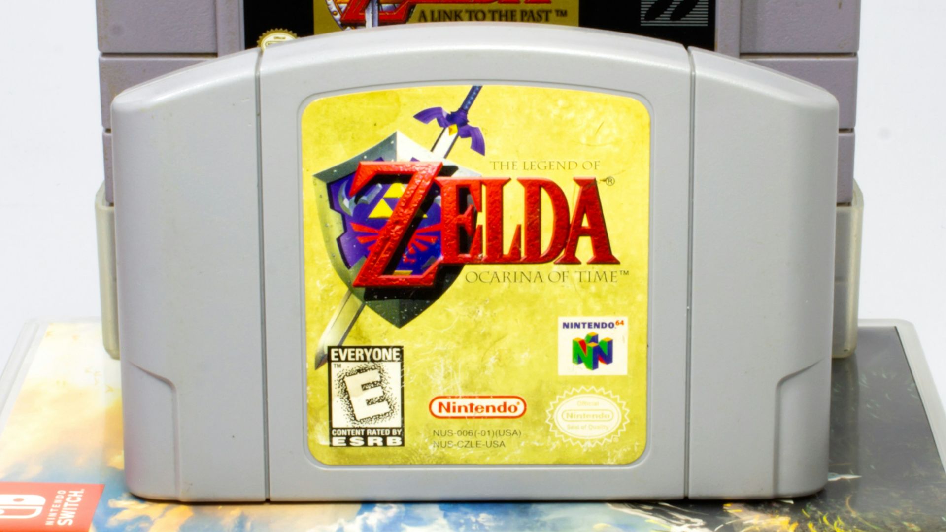 a nintendo game console sitting on top of a stack of books