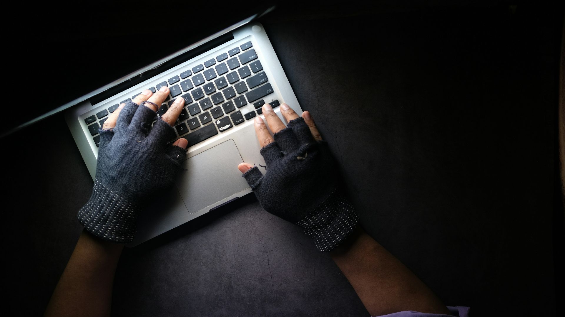 person in black long sleeve shirt using macbook pro