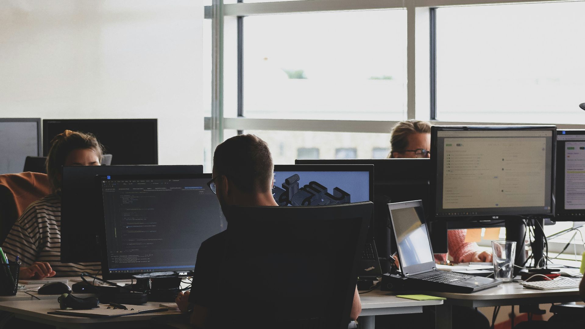 people sitting on chair in front of computer monitor