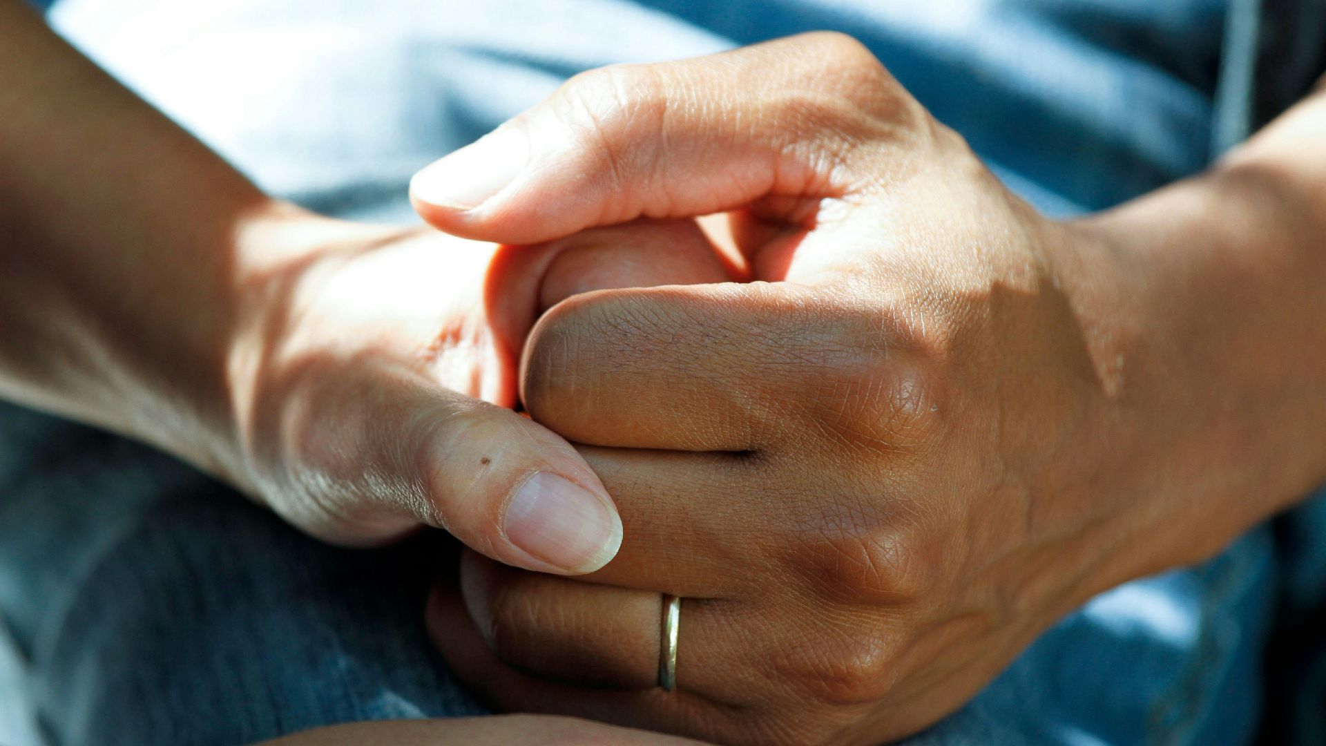 person wearing gold wedding band