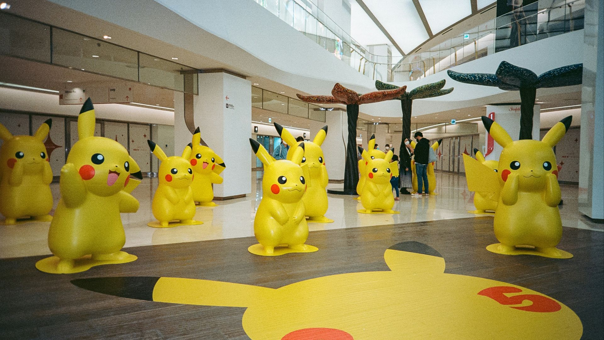 a group of pikachu statues in a building