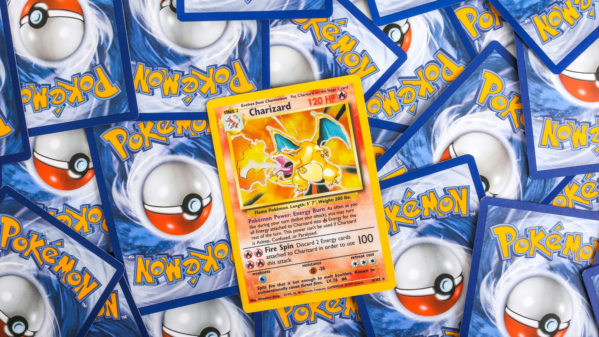 a pile of pokemon trading cards sitting on top of each other
