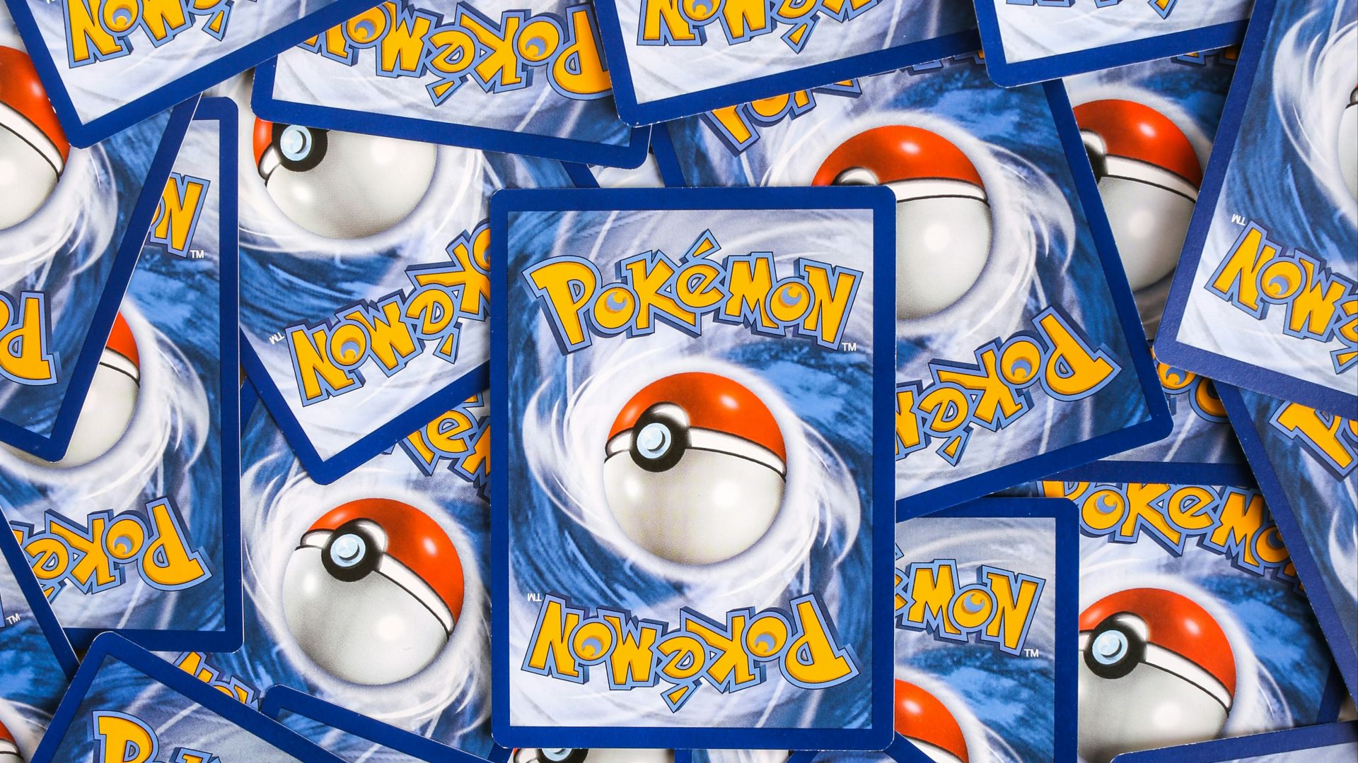 a pile of pokemon trading cards sitting on top of each other