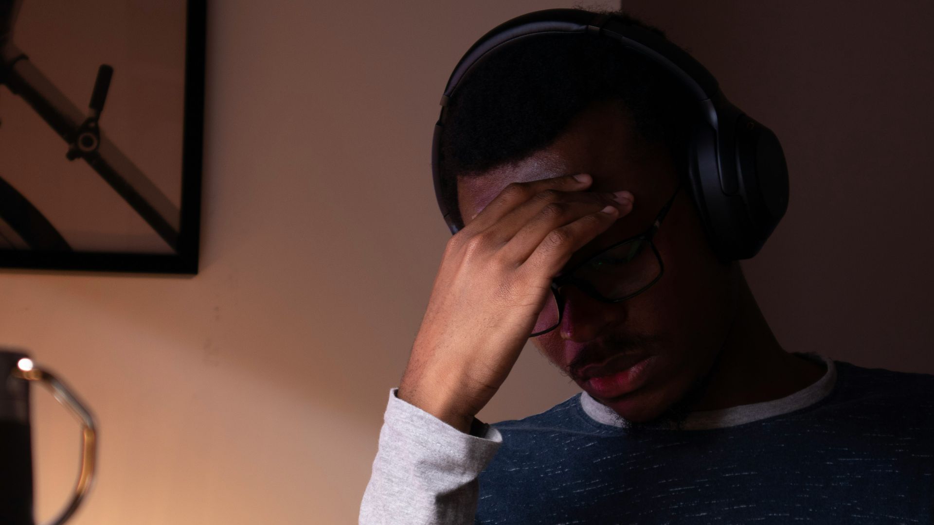 woman in gray sweater covering her face