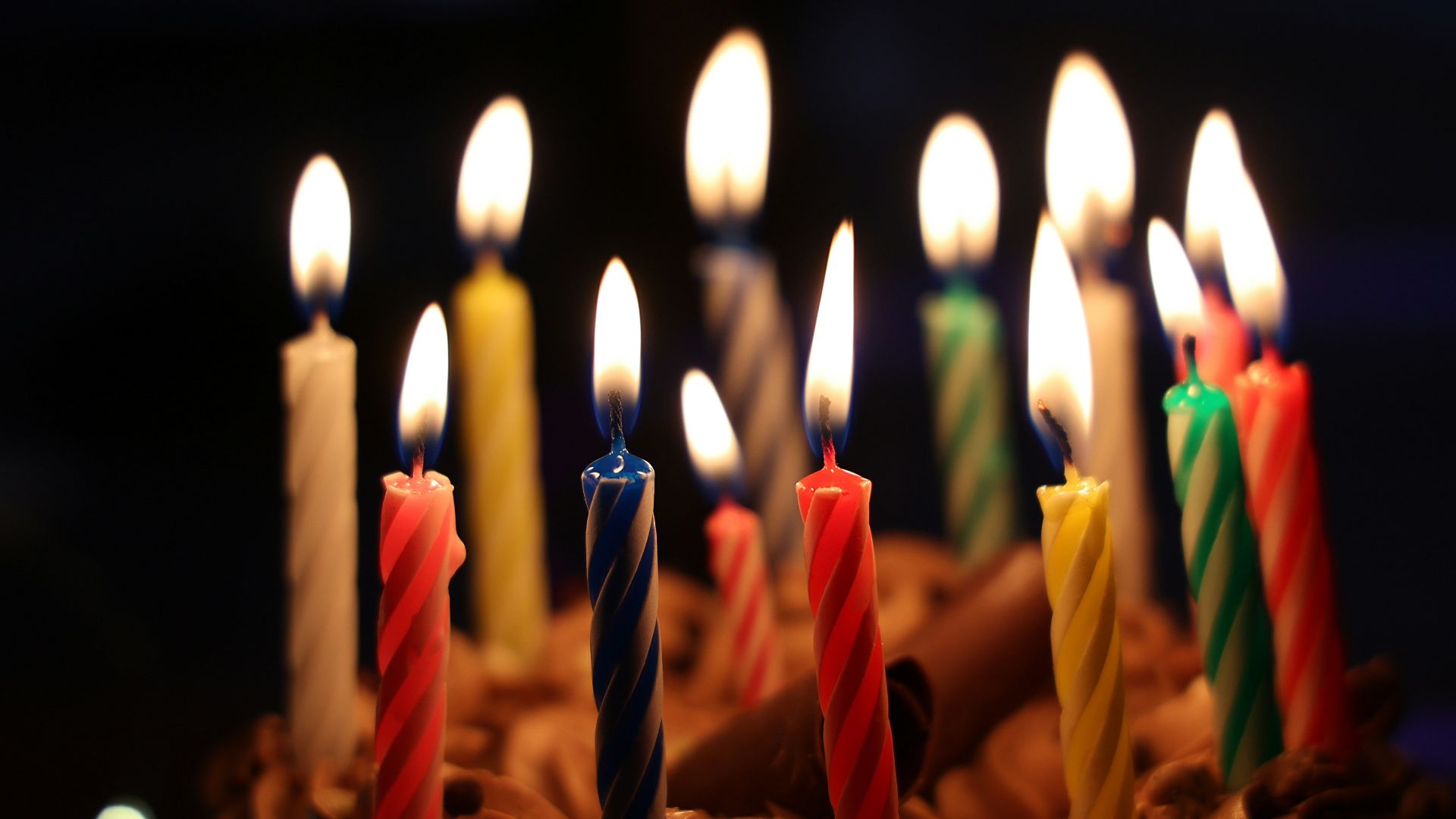 lighted candles on brown cake