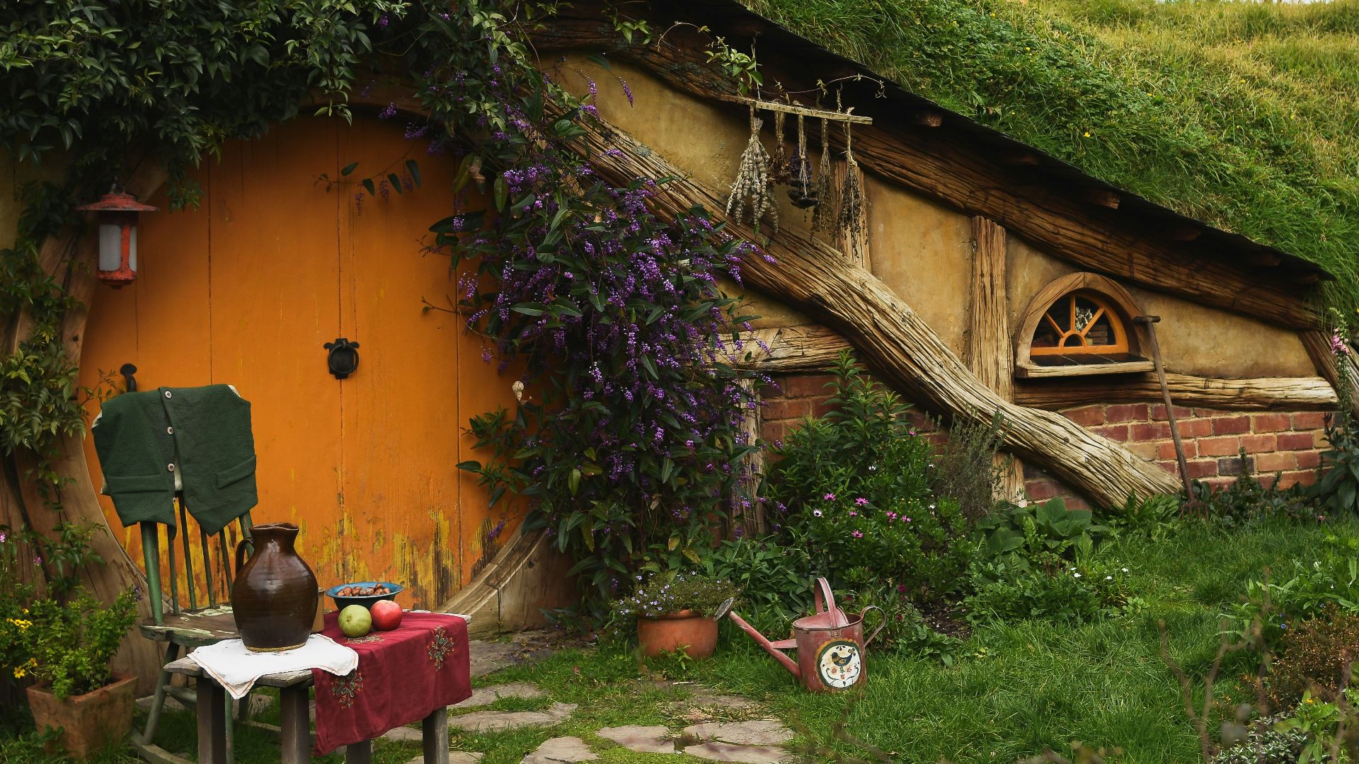 brown wooden house near green grass field during daytime