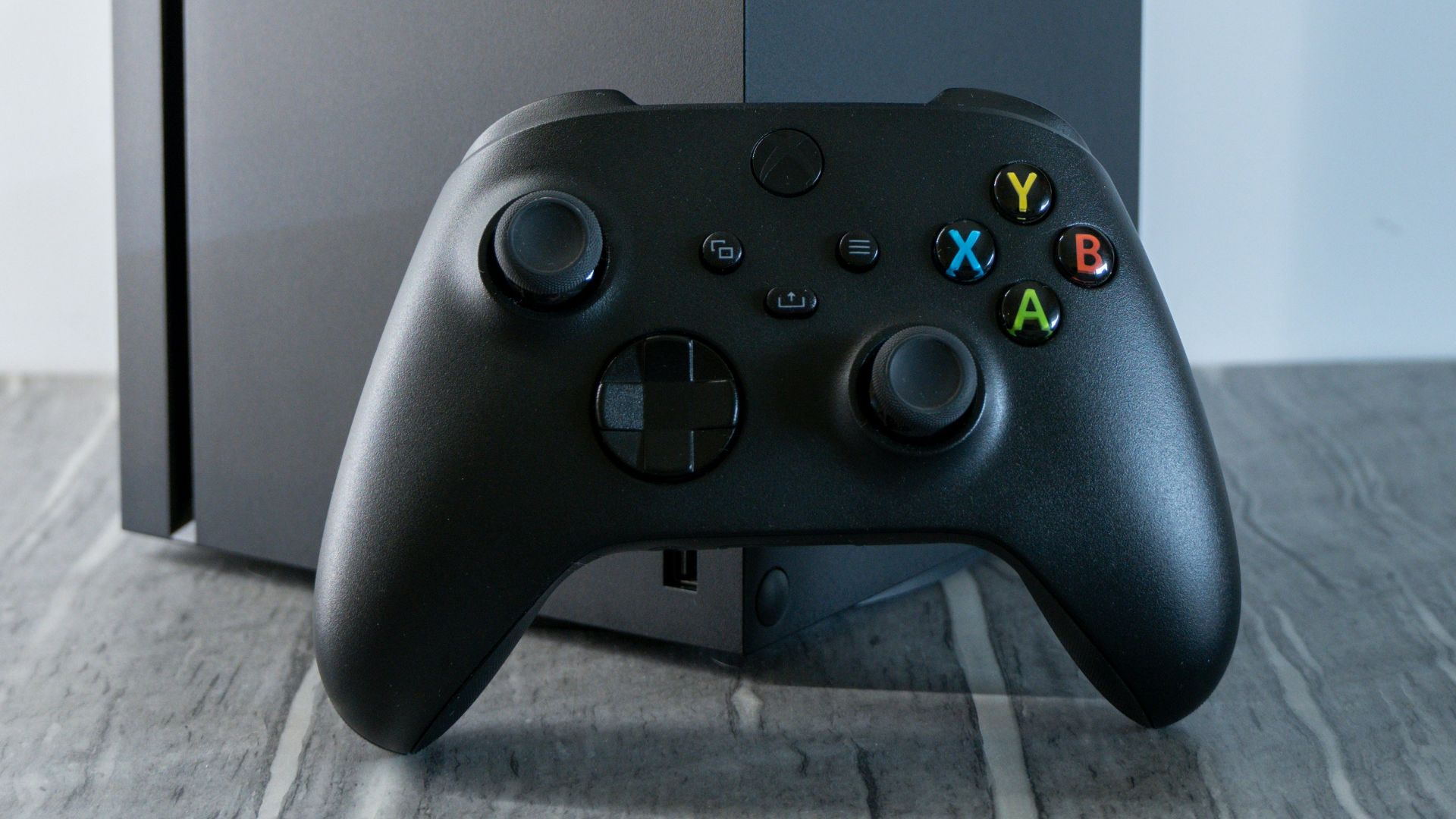 a video game controller sitting next to a box