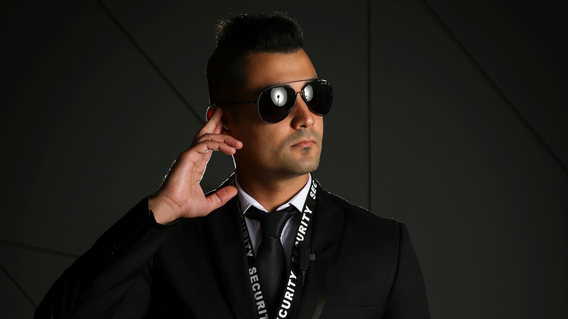 man in black suit wearing black sunglasses