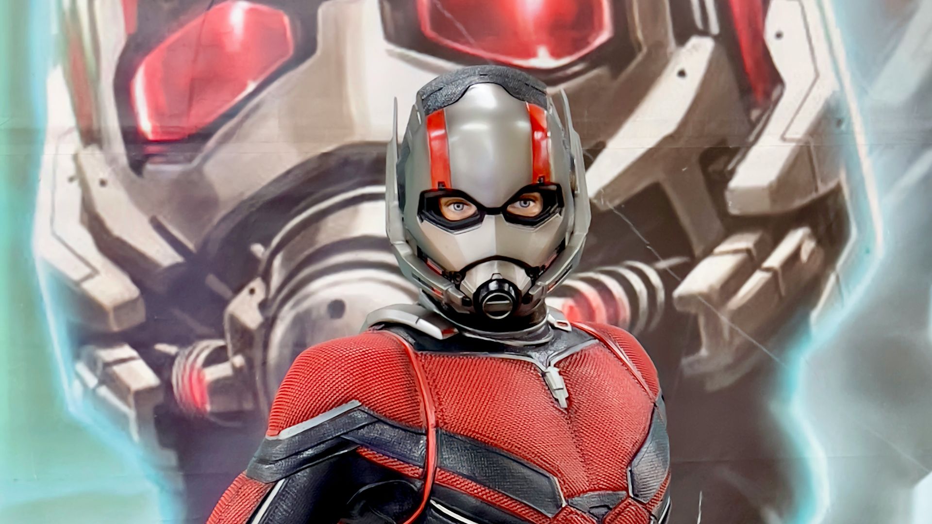 a man in a red and black suit standing next to a giant robot