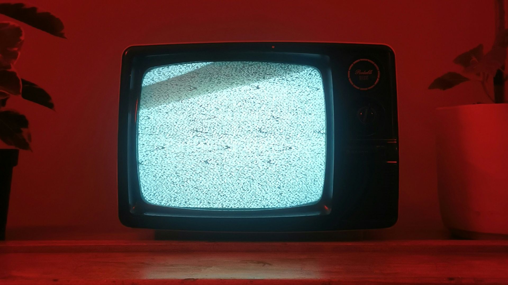 a small television sitting on top of a wooden dresser