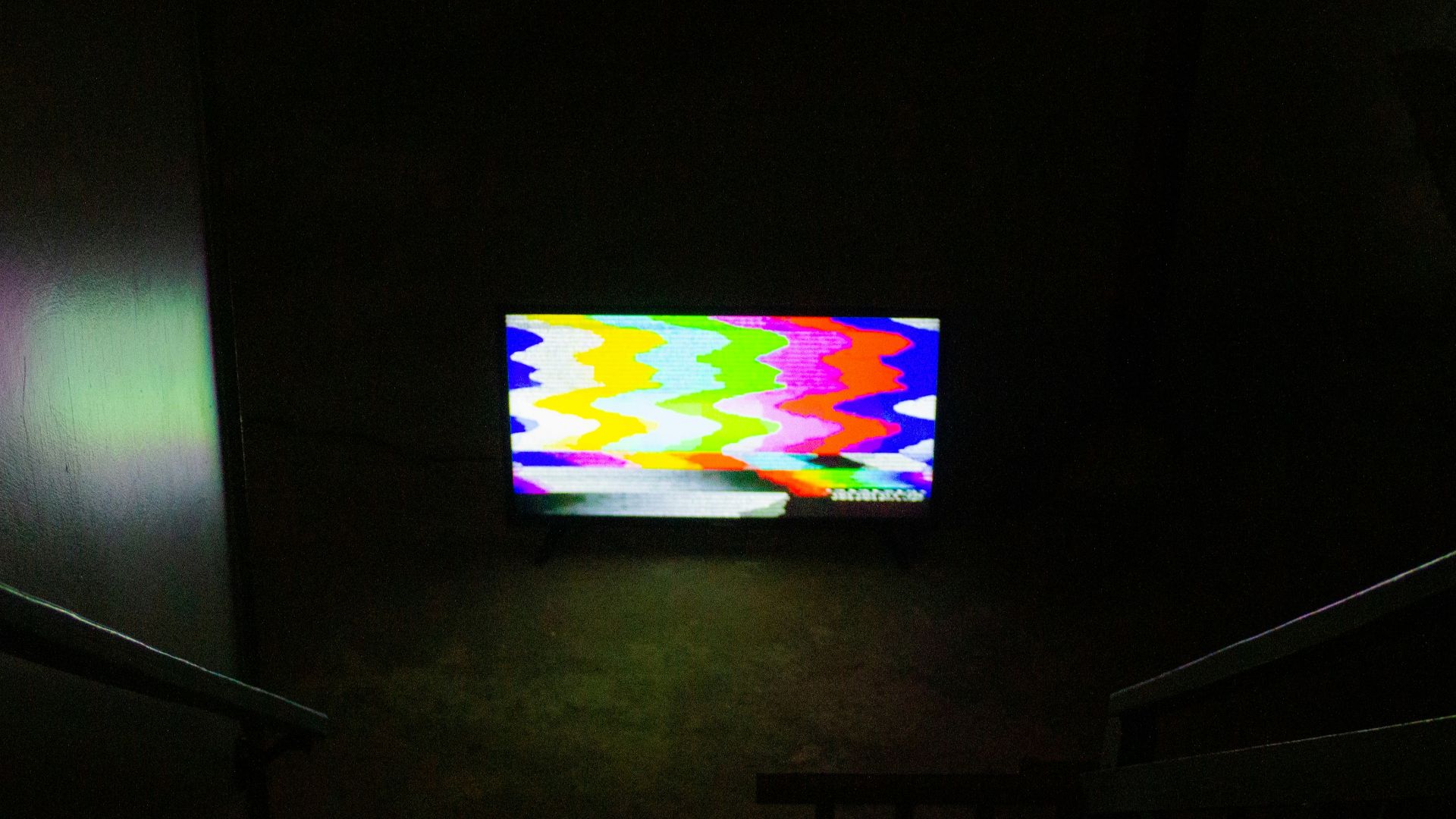 black flat screen tv turned on displaying soccer game