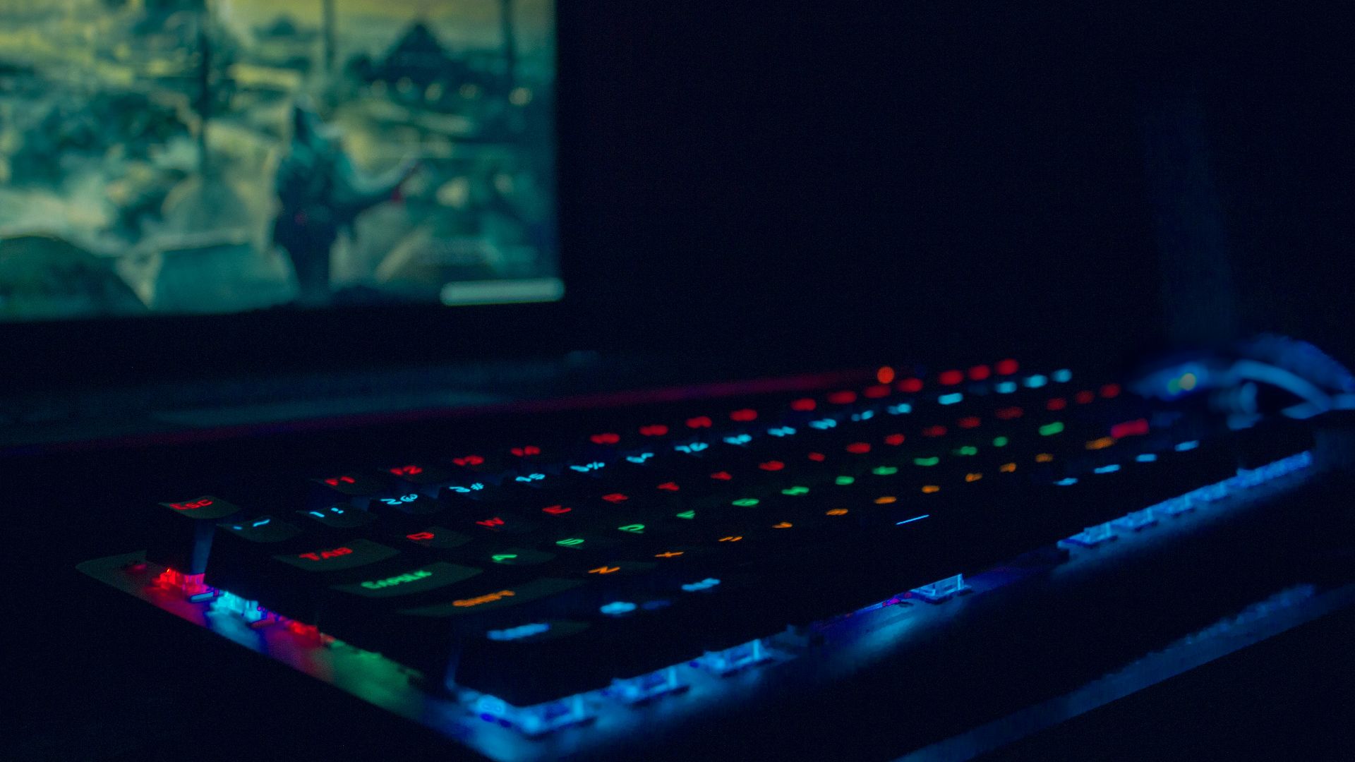 black laptop computer turned on with blue lights