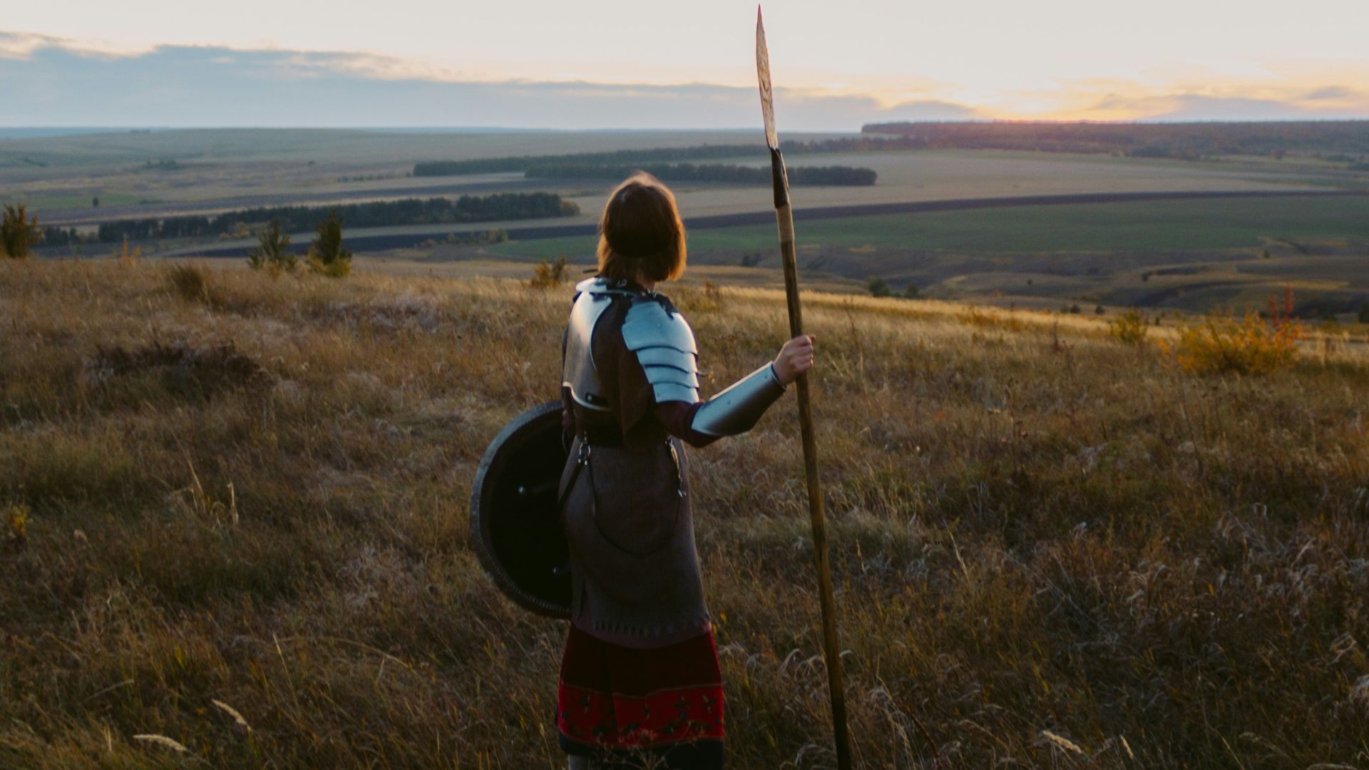 a person with a backpack and a stick in a field