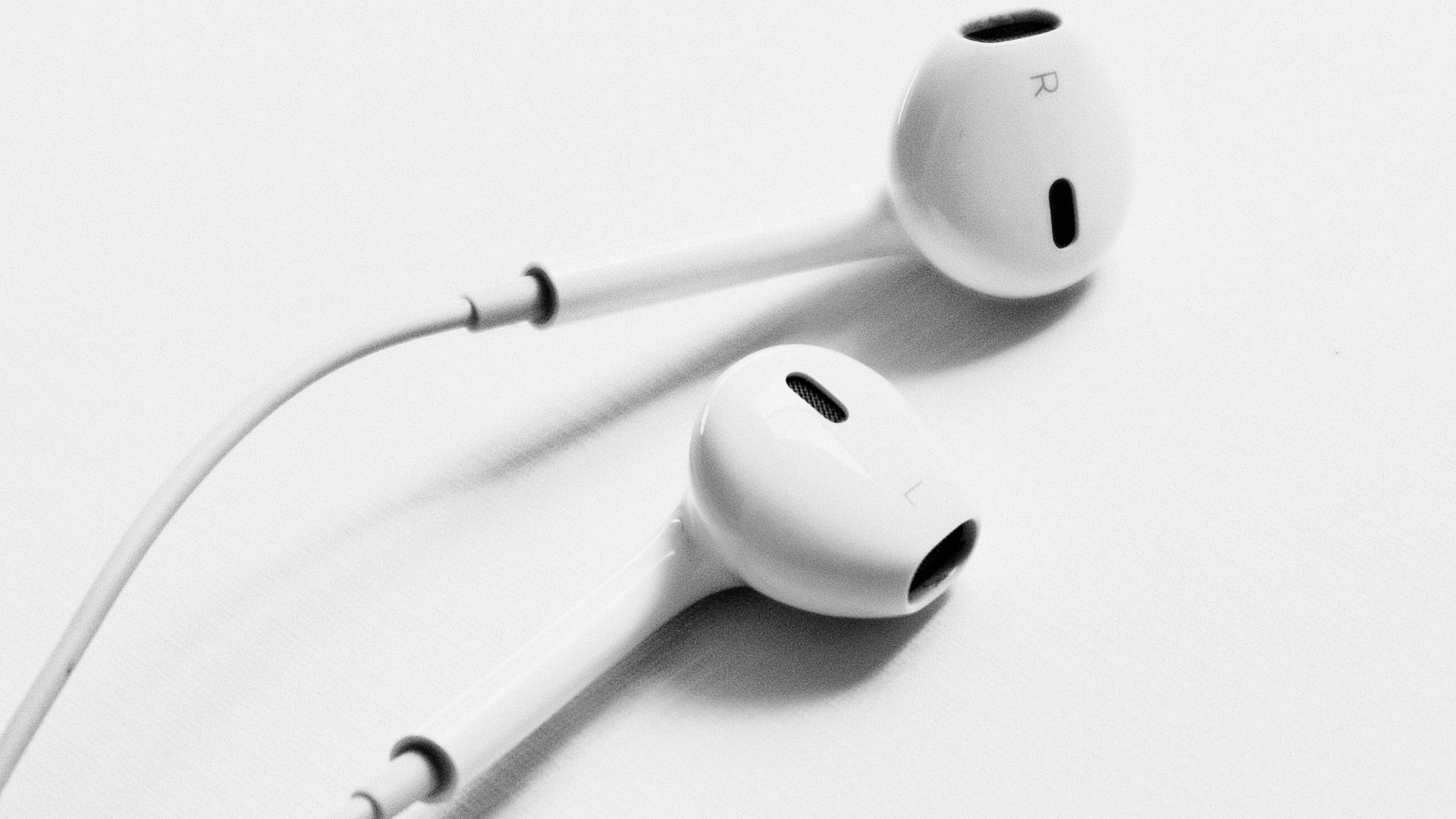 apple earpods on white surface