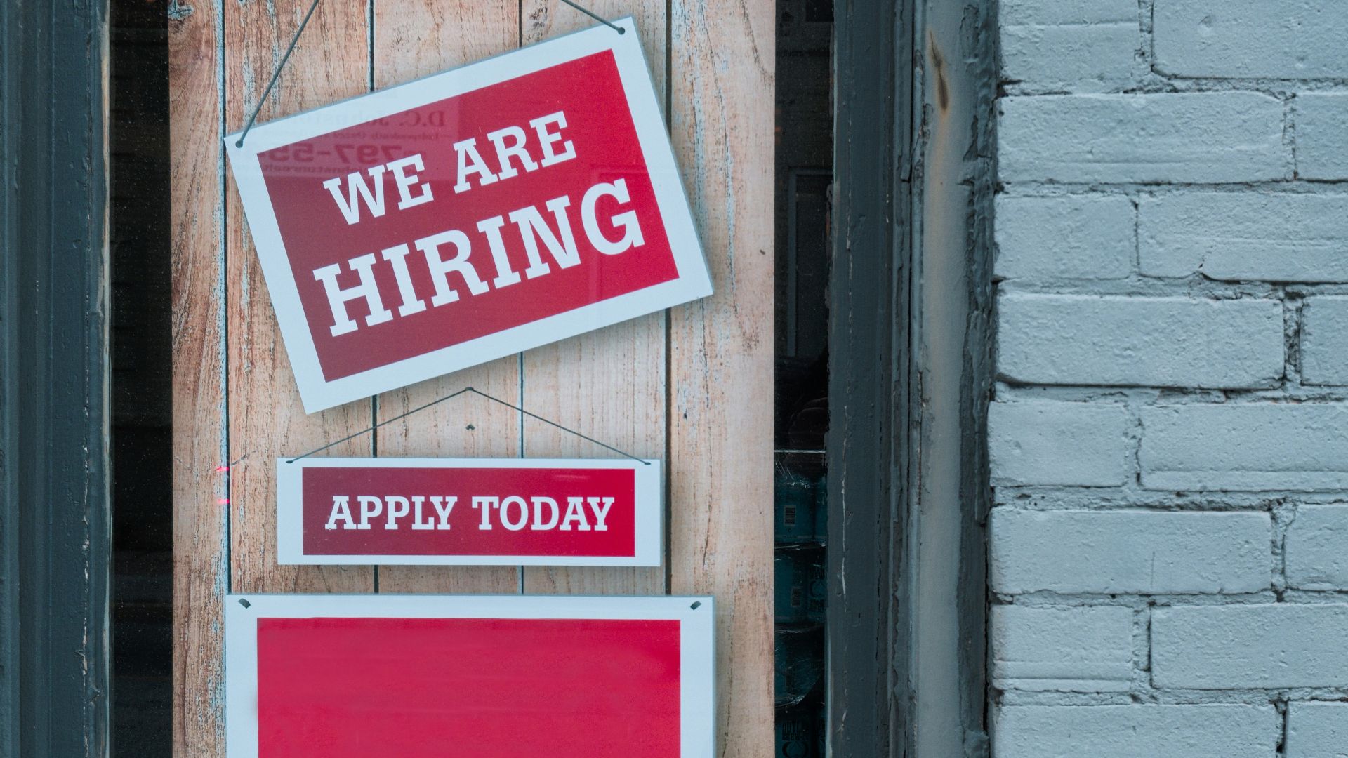 a sign that says we are hiring and apply today