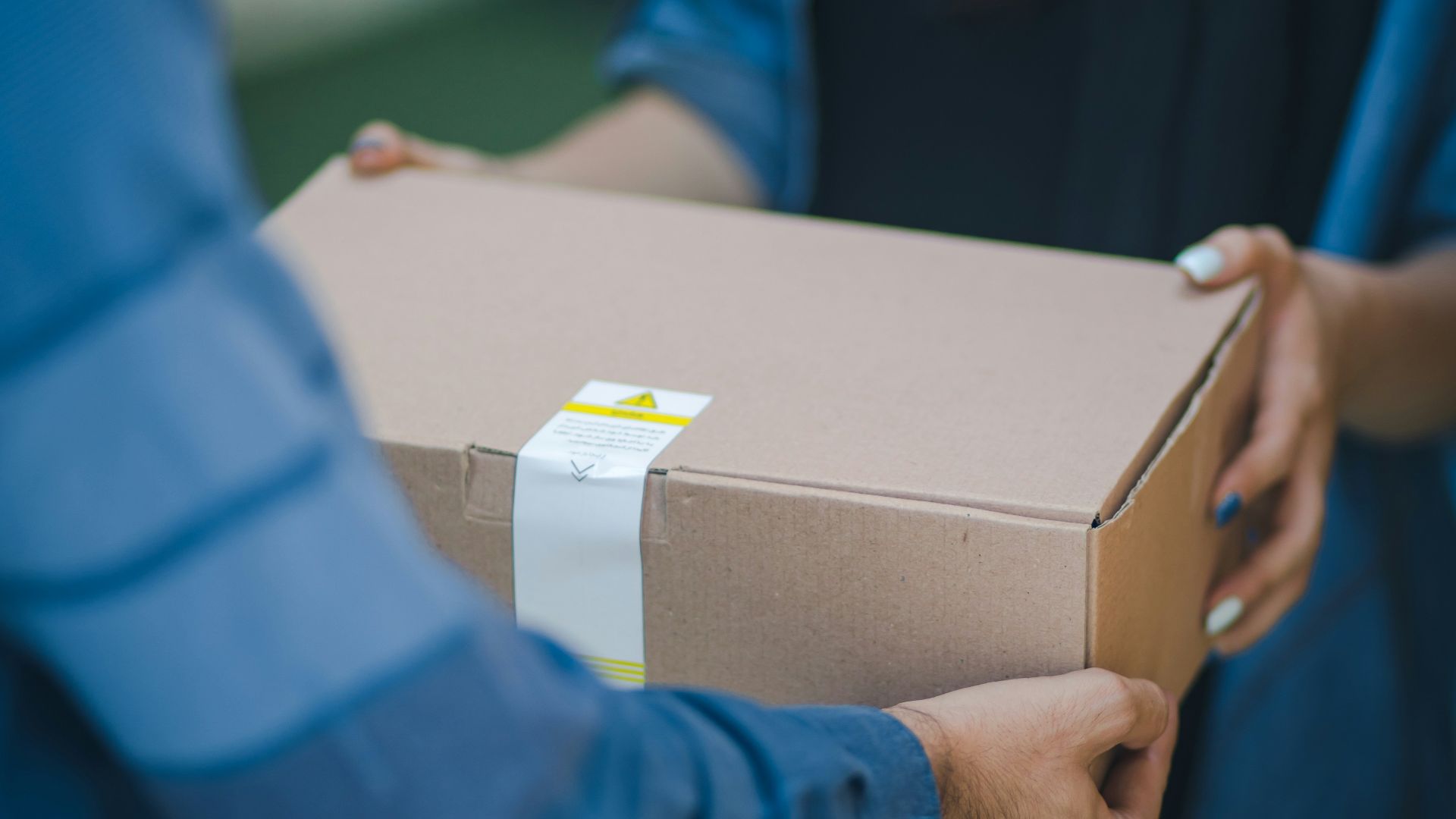 person giving brown box