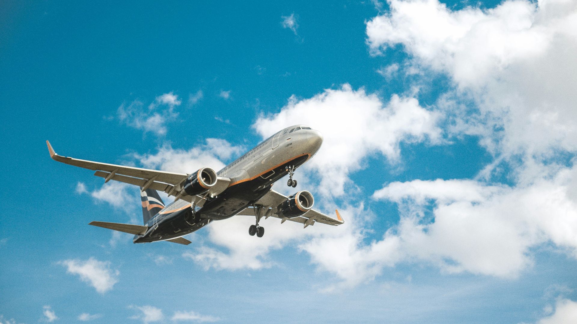 white airplane under blue sky during daytime