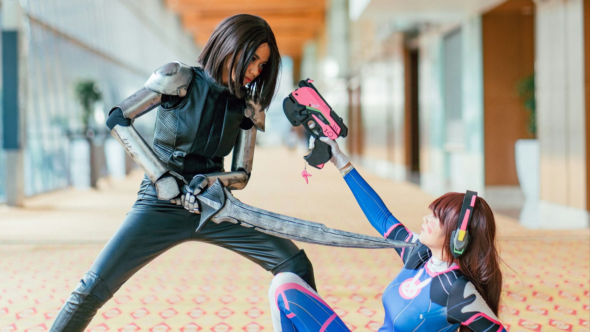 woman pointing sword to another woman