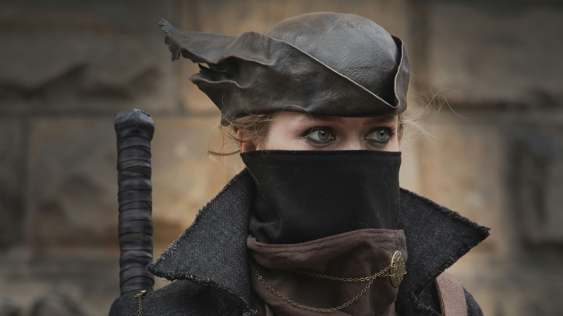 A woman wearing a leather outfit and a hat