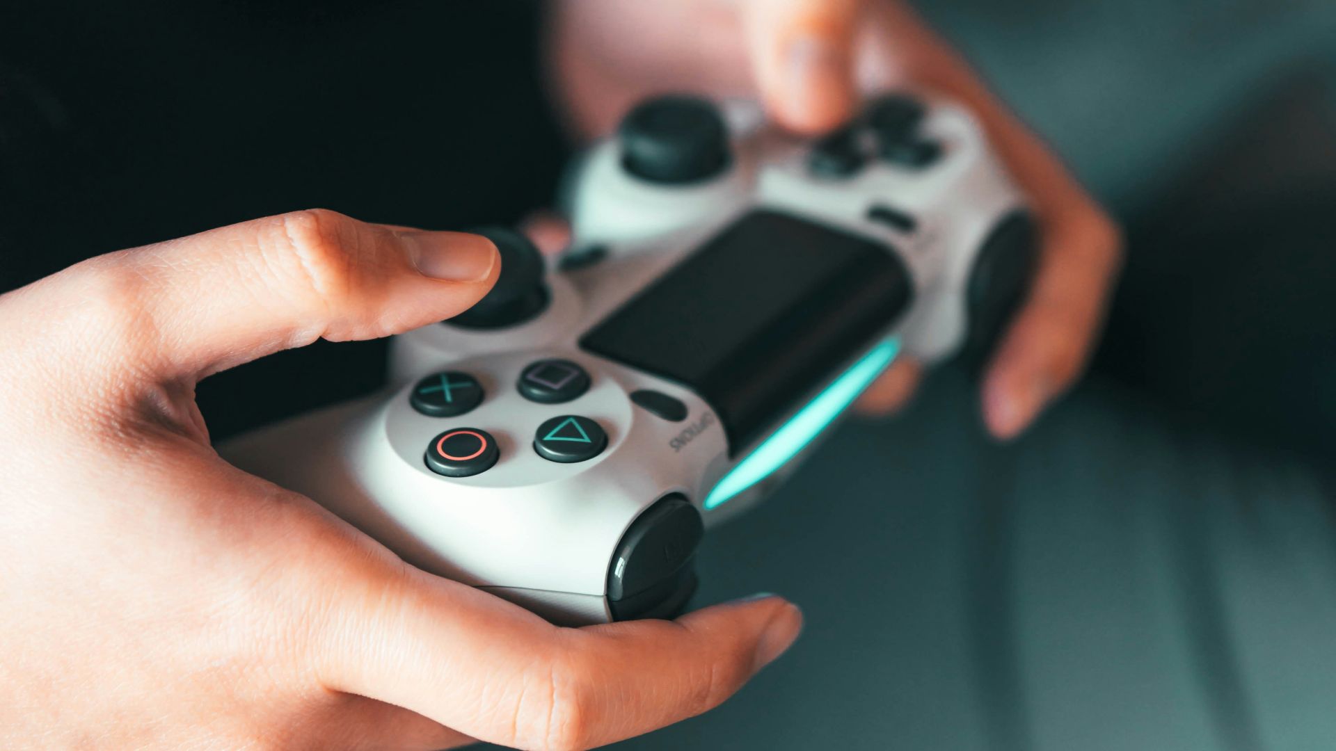 person holding gray game controller