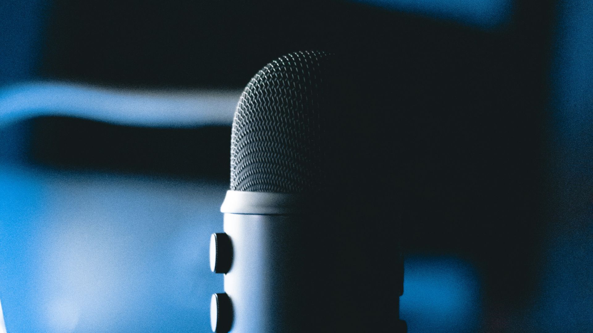 black microphone on blue and white polka dot textile