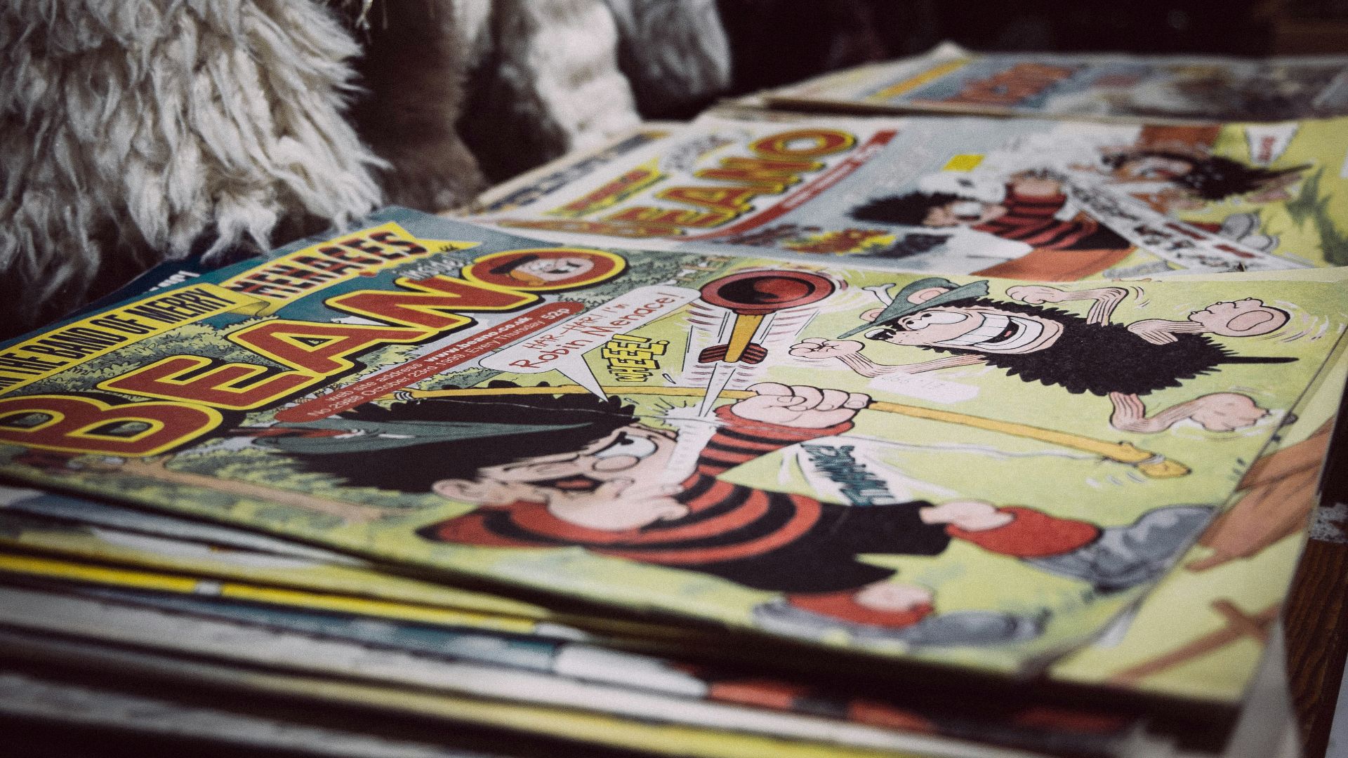 white fur textile on books