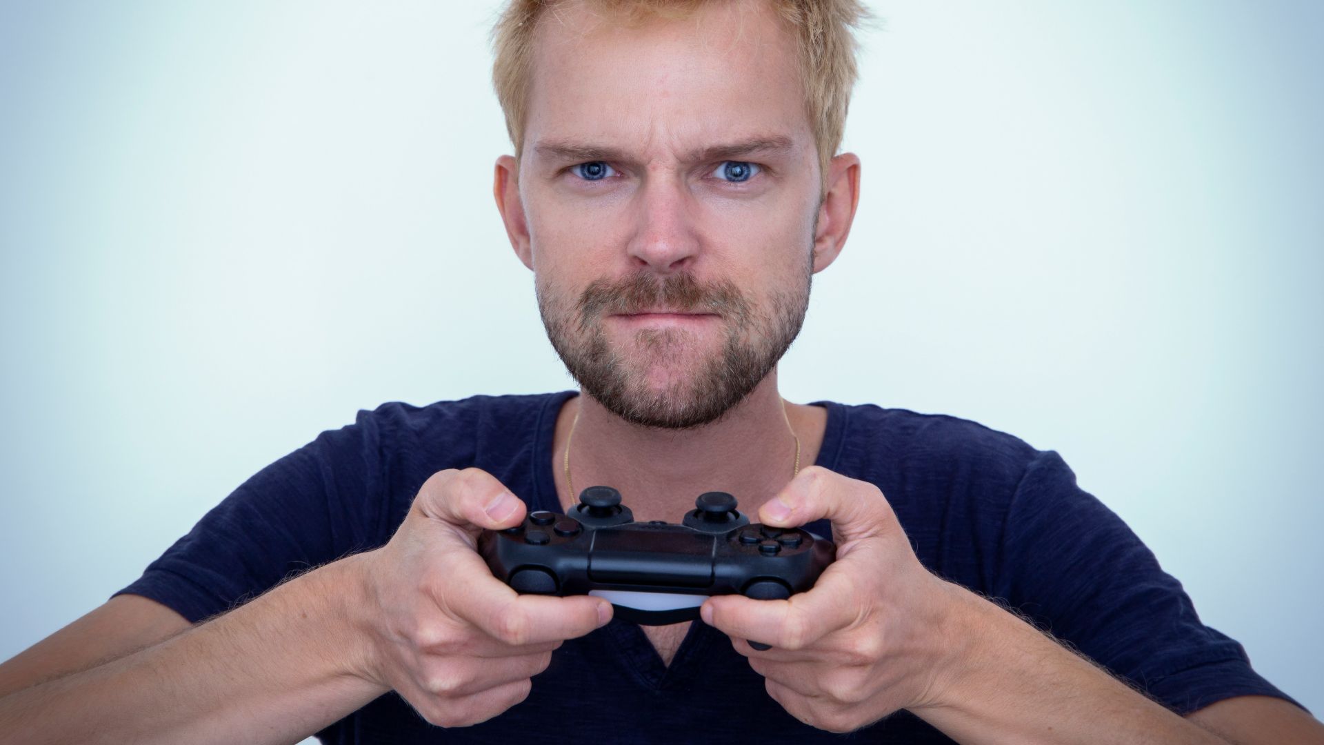 man in blue long sleeve shirt holding black semi automatic pistol