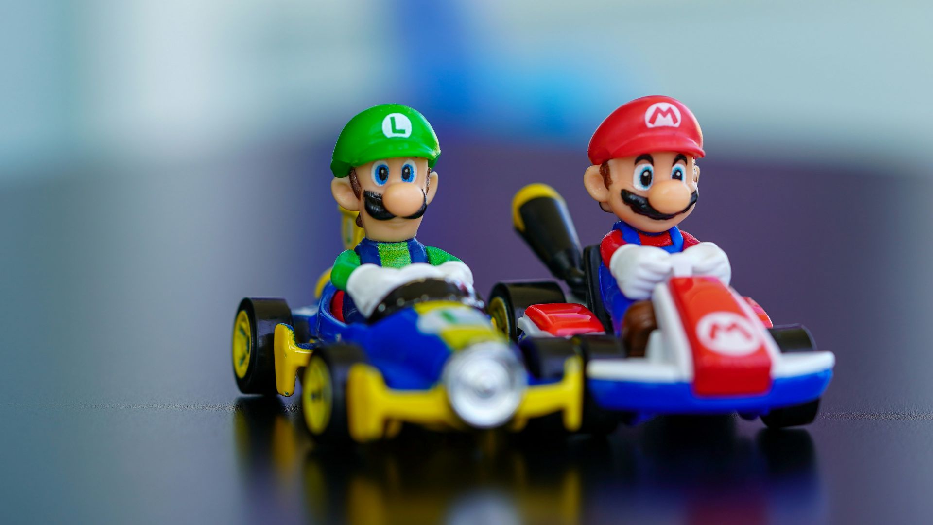 lego mini figure riding blue and red toy car