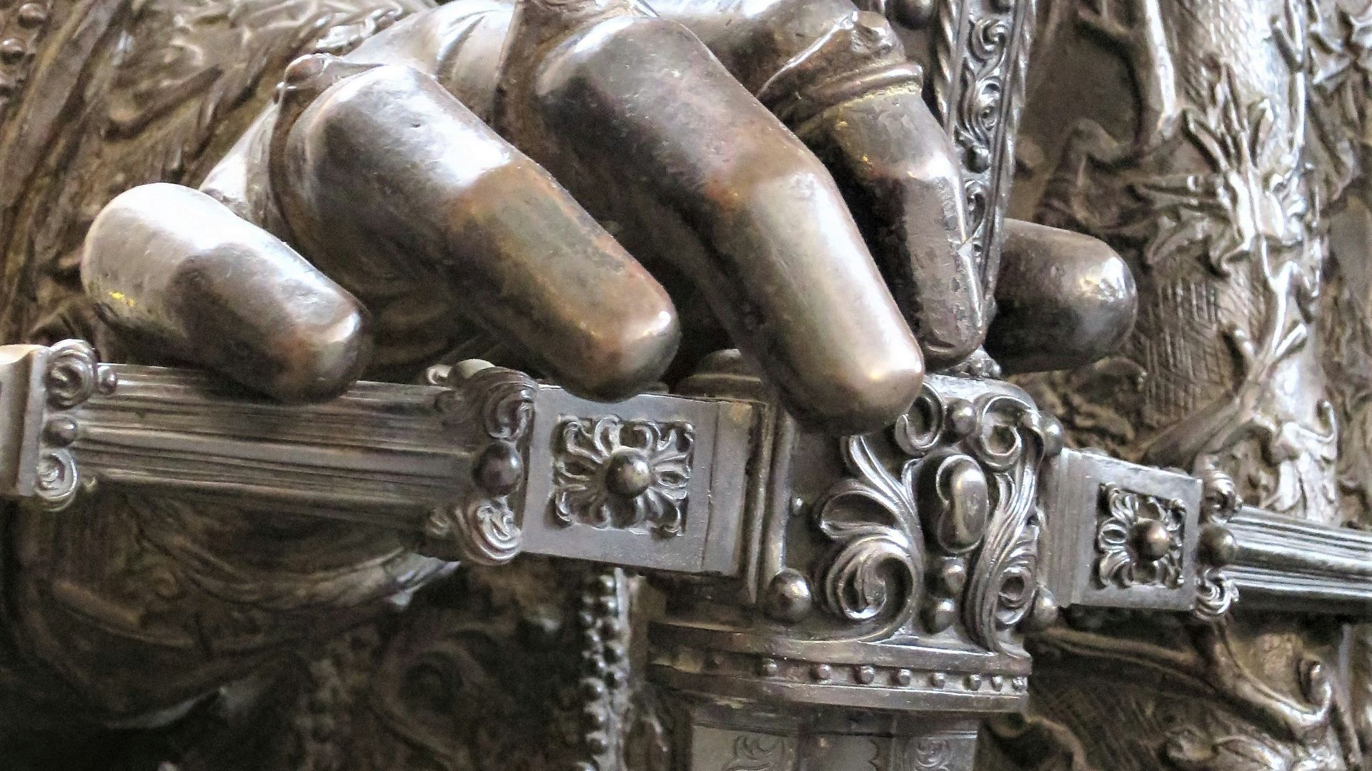 a close up of a statue of a person holding a sword