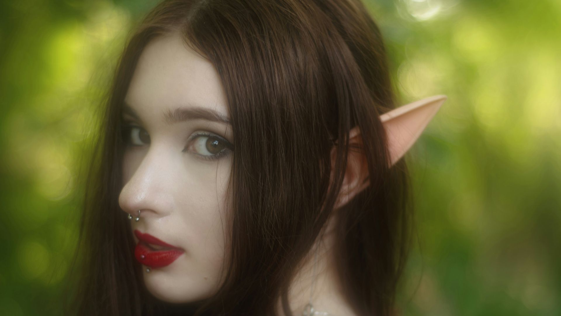 A woman cosplaying as a forest elf.