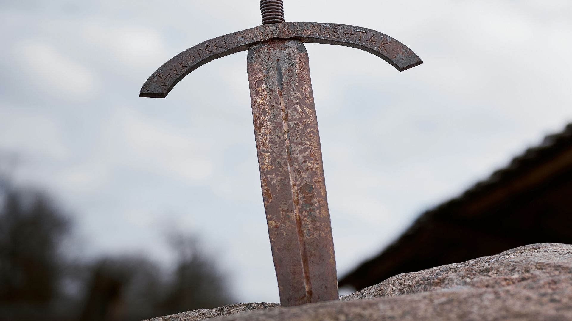 A rusty sword stuck in a stone