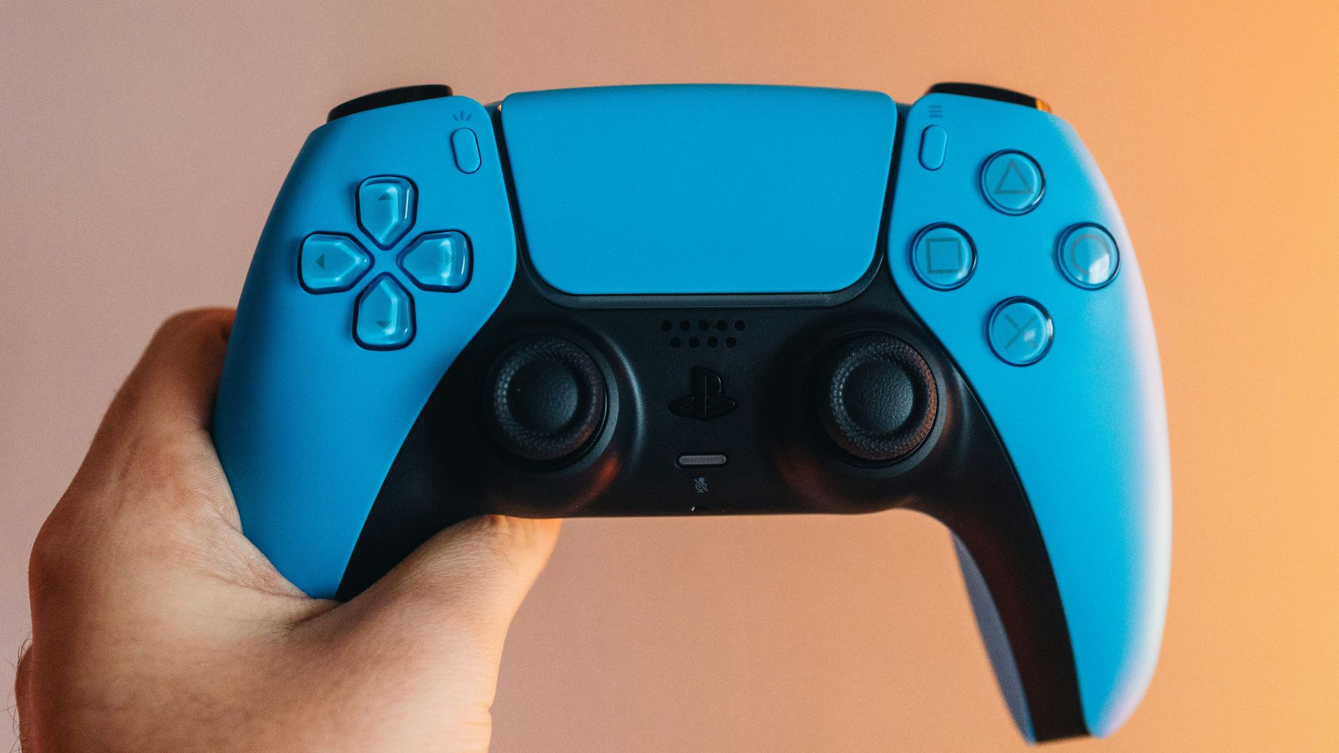 a person holding a blue video game controller