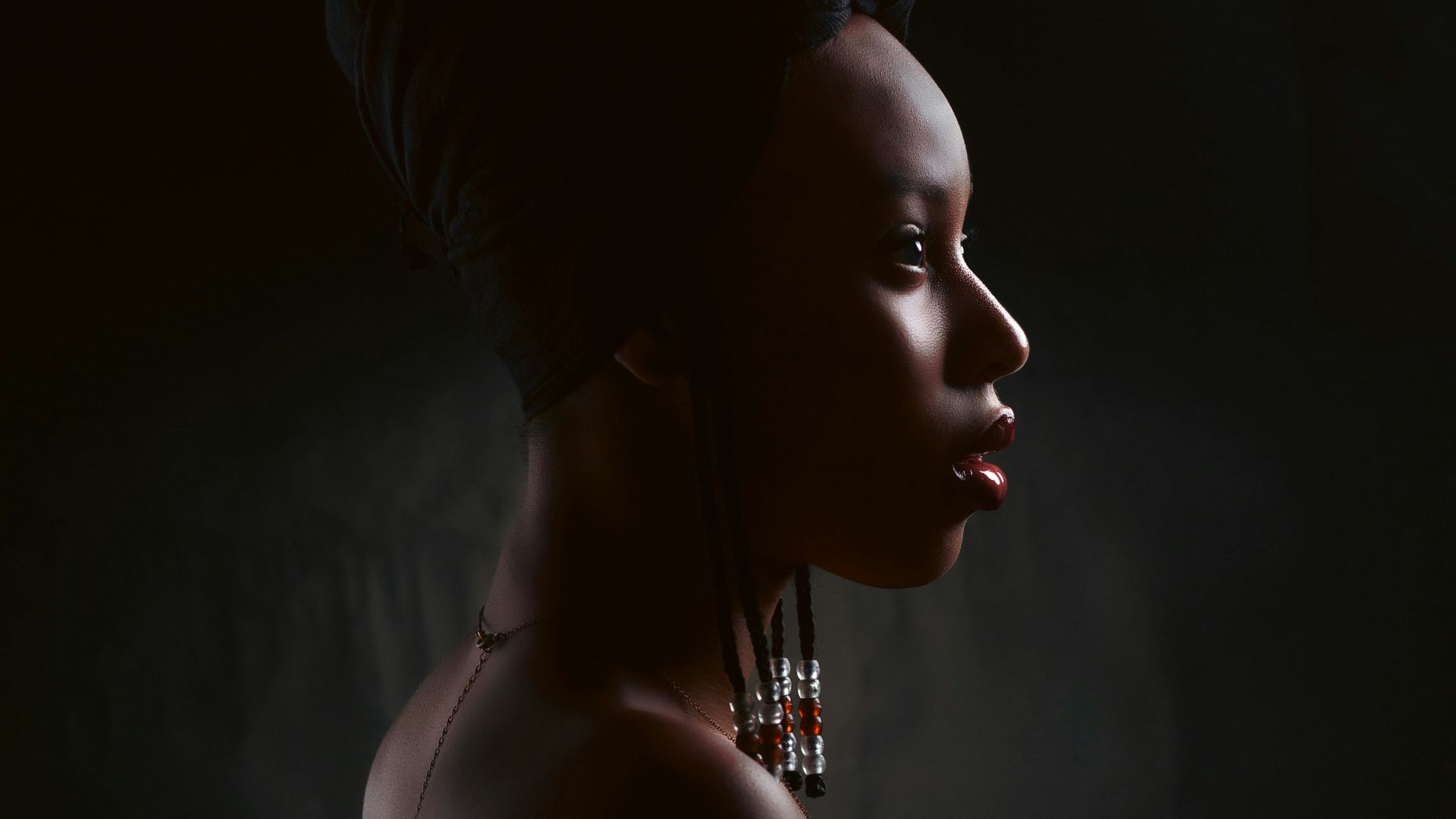 a woman wearing a head scarf and earrings