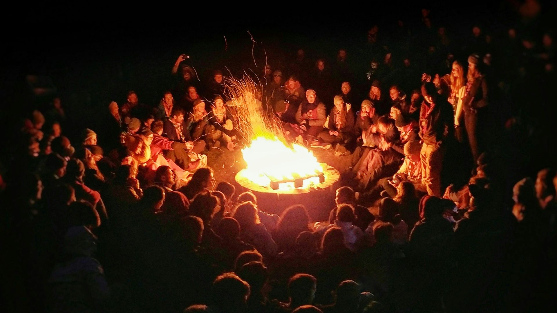 people gathering near bonefire