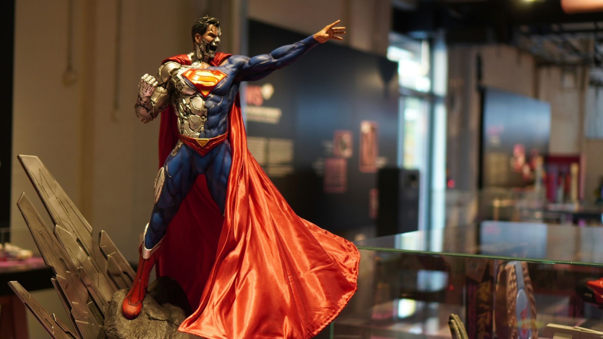 a statue of a person in a red dress and a cape