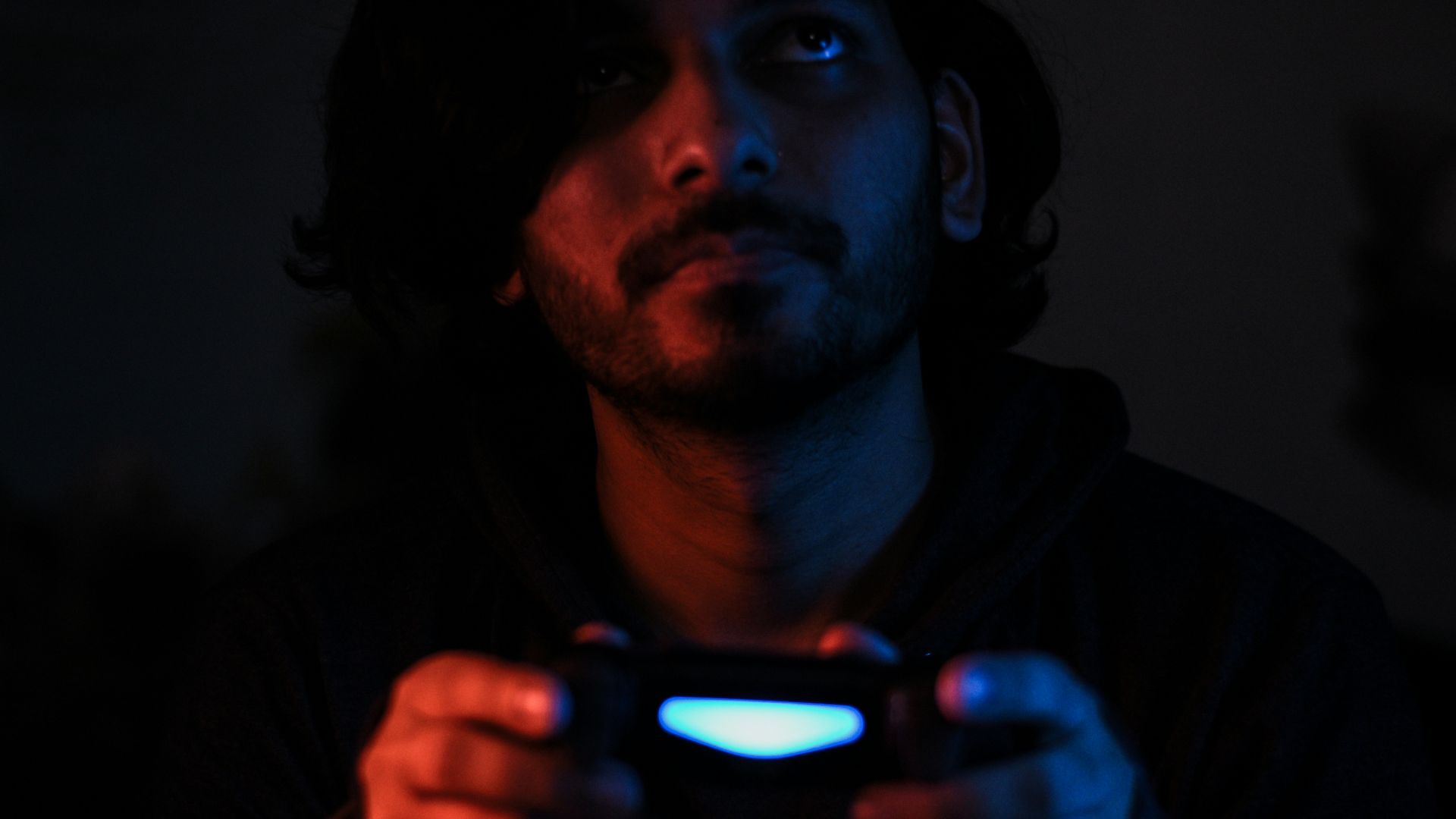 man in black jacket holding black smartphone