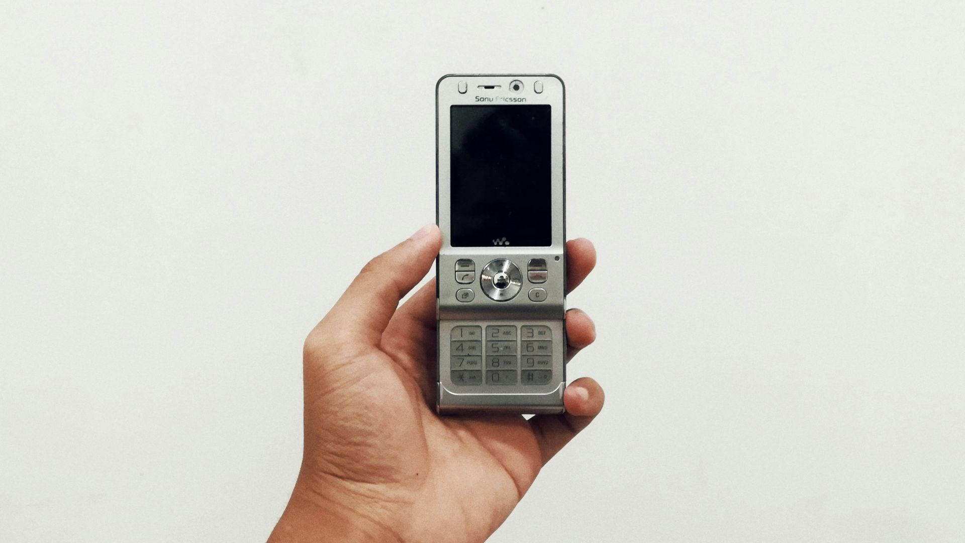 person holding gray candybar phone
