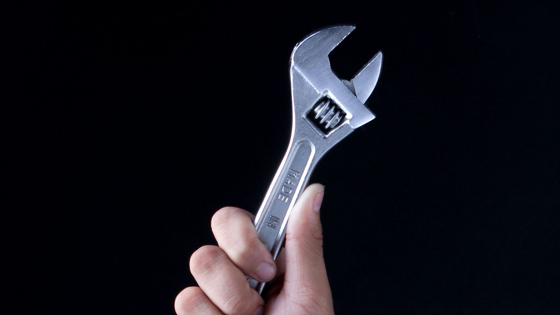 person holding gray and black metal tool