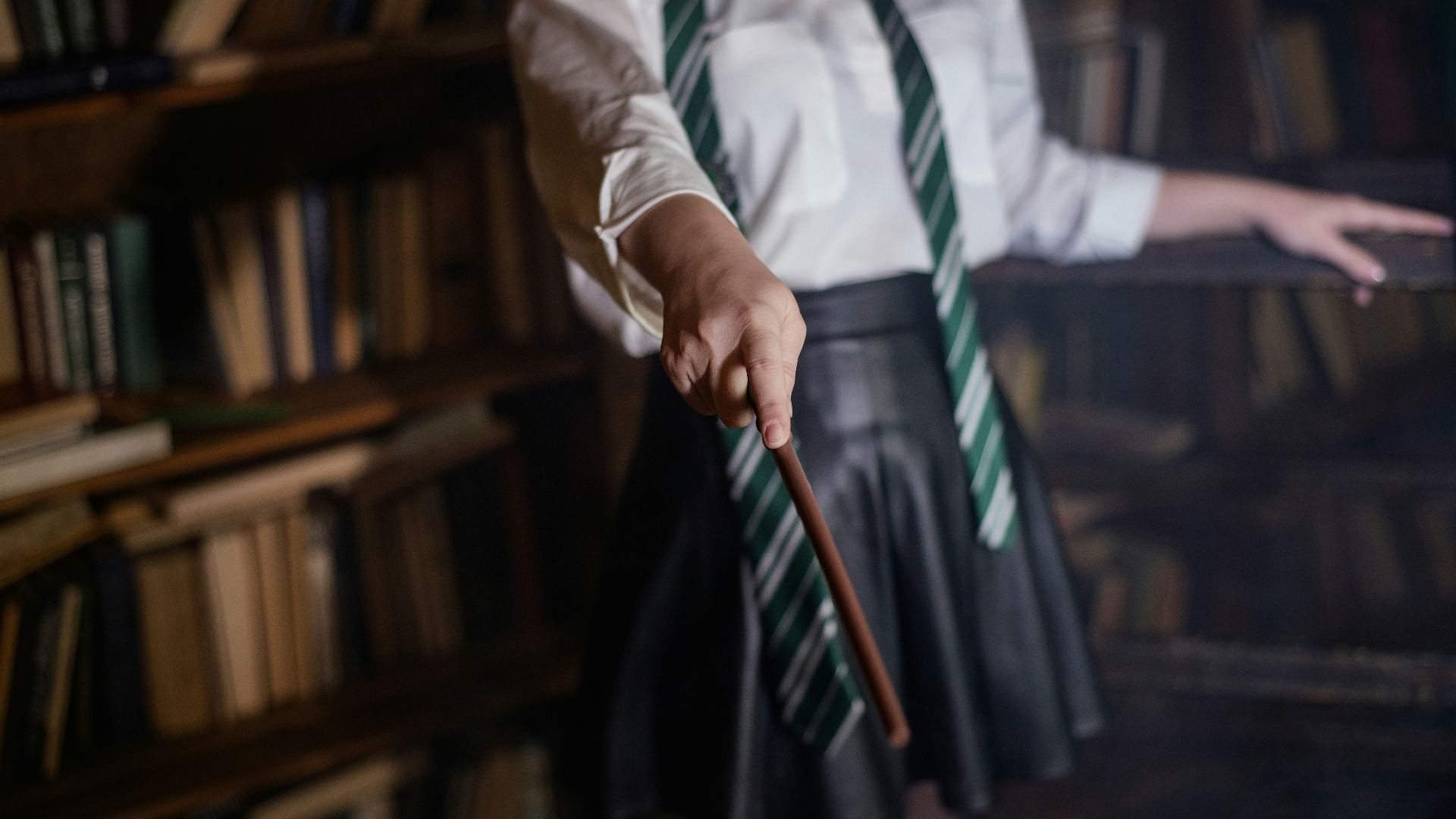 A woman in a white shirt and green tie holding a cane
