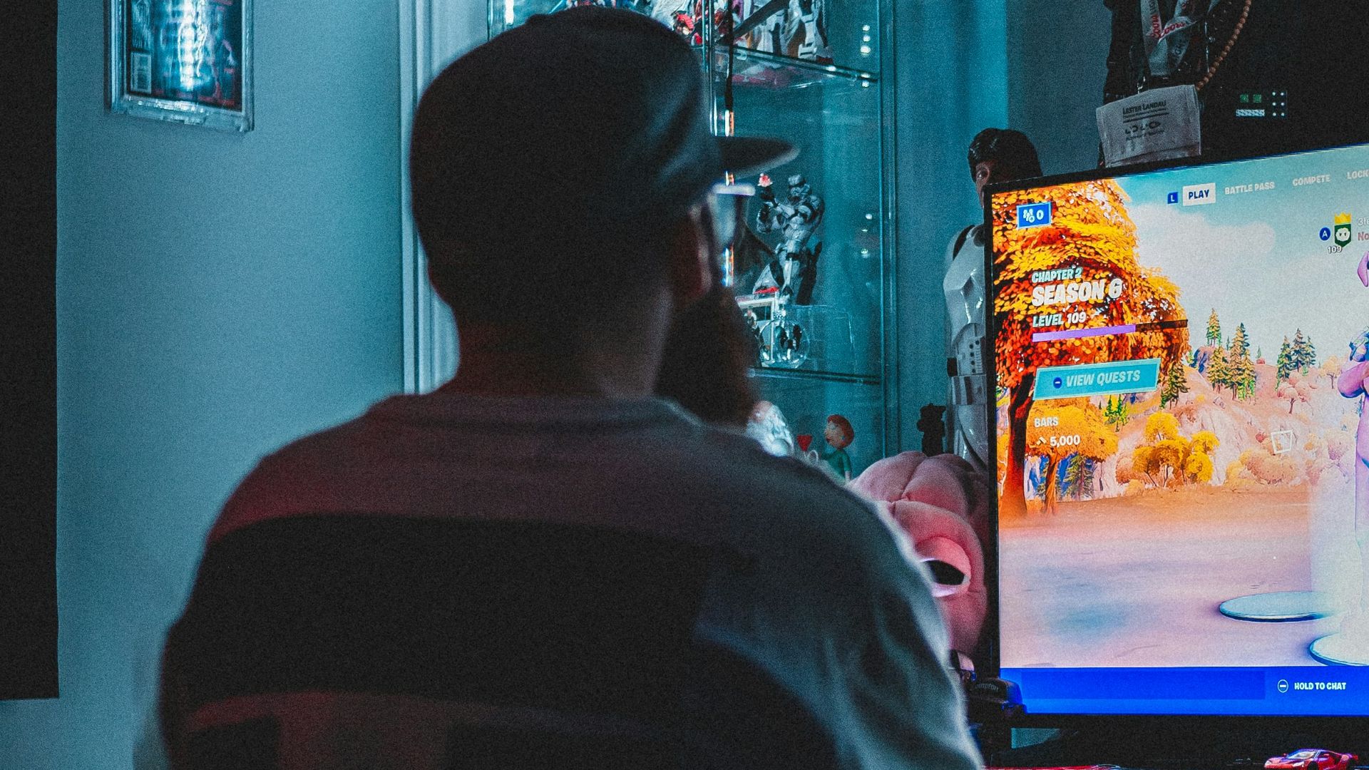 man in red shirt watching tv