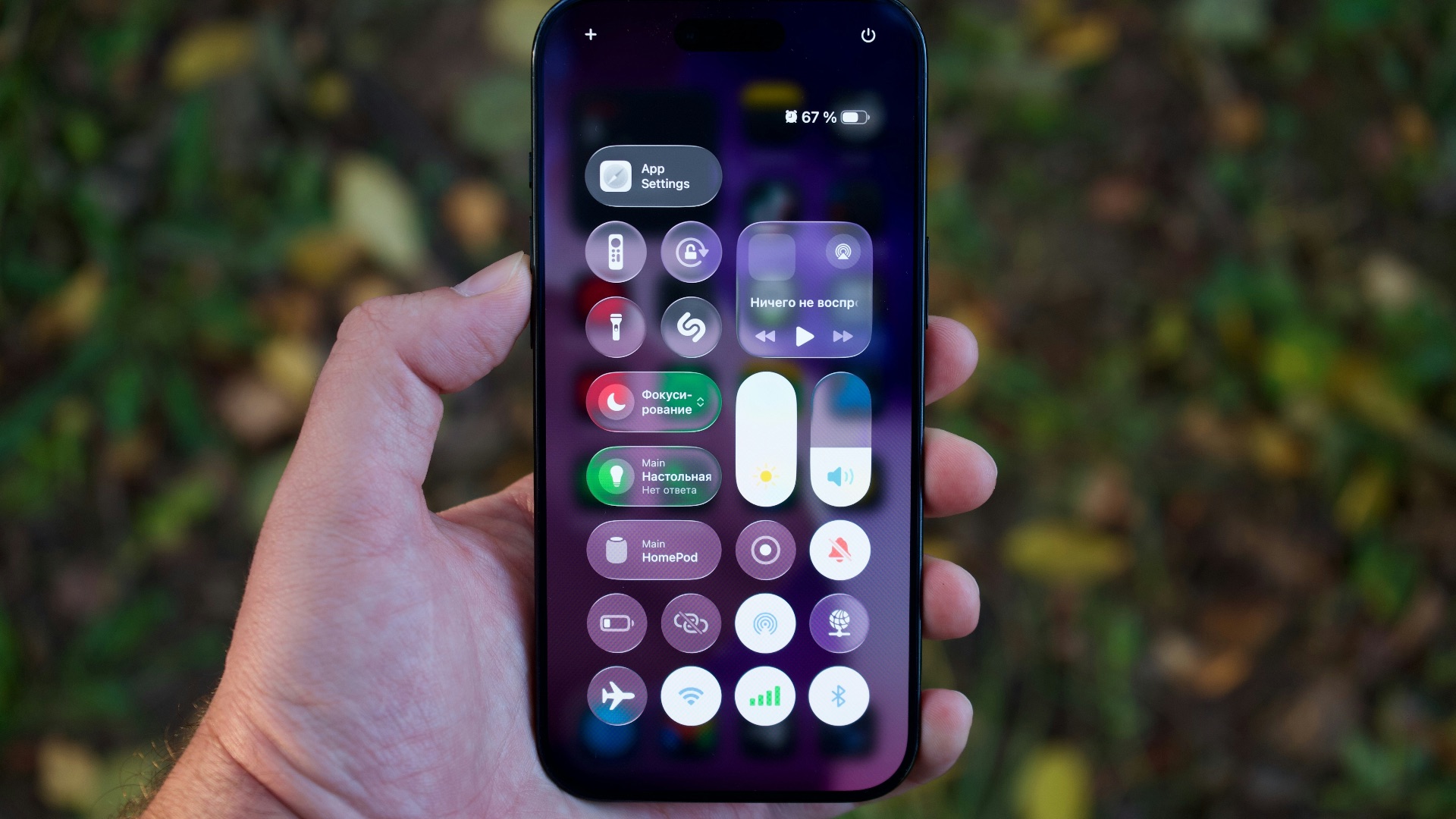 Hand holding a smartphone with colorful app icons.