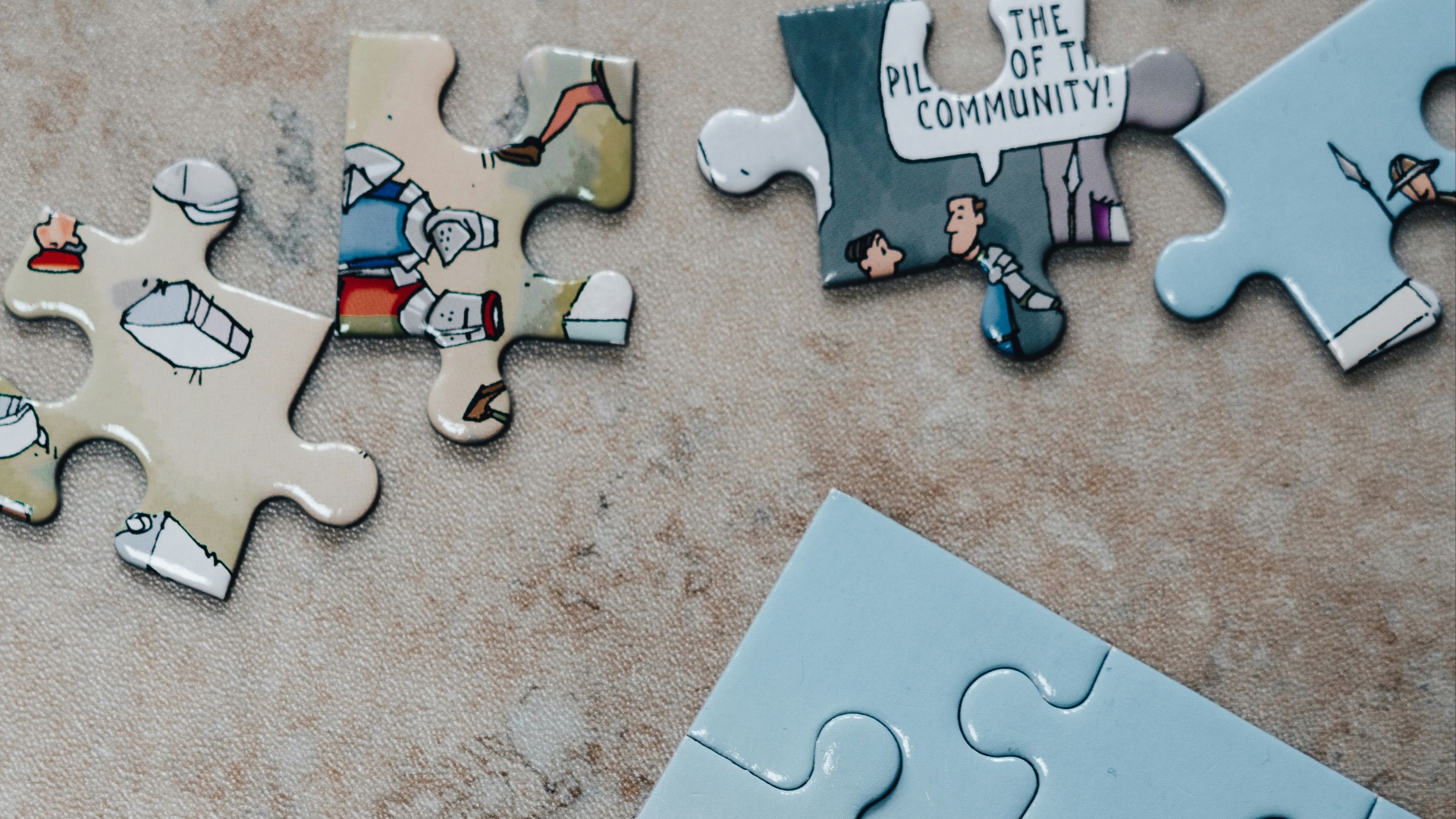 white jigsaw puzzle pieces on brown marble table
