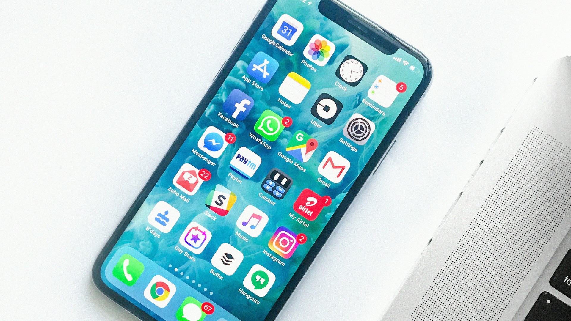 white smartphone near laptop