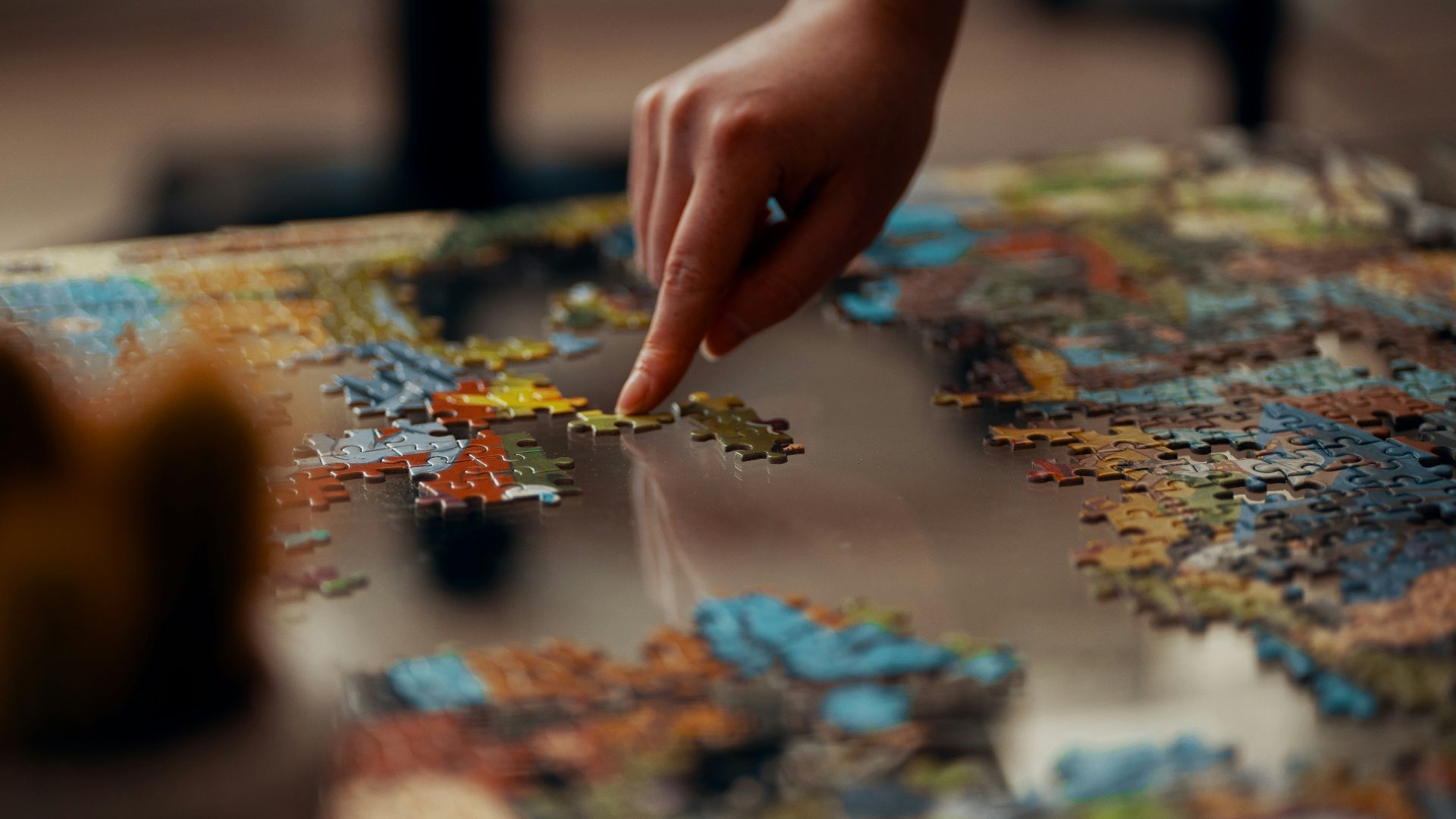 person holding jigsaw puzzle piece